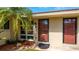 Close up of condo entrance with beautiful landscaping, exterior lighting and unit number above the door at 2259 Pueblo Ln # V38, Sarasota, FL 34231