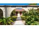 Close up of condo entrances with well-maintained lawns and landscaping leading to the front doors at 2259 Pueblo Ln # V38, Sarasota, FL 34231