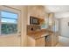 Bright kitchen featuring a granite countertop, stainless steel dishwasher and cabinets at 2259 Pueblo Ln # V38, Sarasota, FL 34231