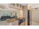 Bright kitchen featuring granite countertops and stainless steel appliances adjacent to the cozy living room at 2259 Pueblo Ln # V38, Sarasota, FL 34231