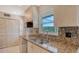 Close-up of a kitchen with granite counters, light wood cabinets and stainless steel appliances at 2259 Pueblo Ln # V38, Sarasota, FL 34231
