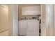 Laundry room featuring a washer and dryer, white louvered doors, and white storage cabinets above at 2259 Pueblo Ln # V38, Sarasota, FL 34231