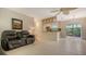 Open-concept living and dining area with tile flooring and sliding glass doors to the patio at 2259 Pueblo Ln # V38, Sarasota, FL 34231