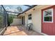 Enclosed patio featuring tile flooring, natural light, access door, and screen enclosure at 2259 Pueblo Ln # V38, Sarasota, FL 34231
