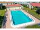 Community pool with lounge chairs, a well-maintained fence and manicured lawn at 2259 Pueblo Ln # V38, Sarasota, FL 34231