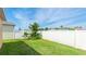 Spacious backyard featuring green grass, privacy fence, and foliage at 2344 28Th E Ave, Palmetto, FL 34221