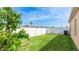 Backyard with a grassy area, privacy fence, and shade tree at 2344 28Th E Ave, Palmetto, FL 34221