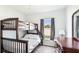 Bedroom with bunk beds, window, and wood-look flooring at 2344 28Th E Ave, Palmetto, FL 34221
