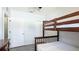 Cozy bedroom features a wooden bunk bed, gray floors and neutral paint at 2344 28Th E Ave, Palmetto, FL 34221