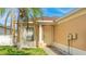 Close up of front entry showing front door, siding, window, and mature landscaping at 2344 28Th E Ave, Palmetto, FL 34221
