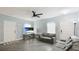 Open living room featuring a ceiling fan and gray wood flooring at 2344 28Th E Ave, Palmetto, FL 34221