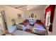 Bright bedroom with twin beds, nautical themed decor, and ceiling fan at 2448 45Th S St, St Petersburg, FL 33711
