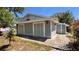 Cozy home featuring light gray siding, complemented by the lush greenery of the surrounding yard at 2448 45Th S St, St Petersburg, FL 33711