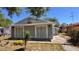 Cozy home featuring light gray siding, complemented by the lush greenery of the surrounding yard at 2448 45Th S St, St Petersburg, FL 33711
