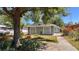 The home has a charming exterior, shaded by a mature tree, and features well-maintained landscaping at 2448 45Th S St, St Petersburg, FL 33711