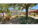 Charming home with inviting curb appeal, shaded by mature tree, surrounded by a landscaped yard at 2448 45Th S St, St Petersburg, FL 33711