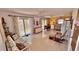 Bright living room features tiled floors, ceiling fans, furniture, and sliding glass door at 2448 45Th S St, St Petersburg, FL 33711