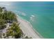 Stunning aerial view of a shoreline with white sand, blue water, and lush green trees at 2537 Ashton Rd, Sarasota, FL 34231