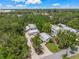 Beautiful aerial view of a home surrounded by lush trees and greenery under a sunny, blue sky at 2537 Ashton Rd, Sarasota, FL 34231