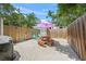 Private backyard with a picnic table, Adirondack chairs, and a grill at 2537 Ashton Rd, Sarasota, FL 34231