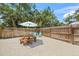 Backyard features a wooden fence, seating around a picnic table, and a stone ground cover at 2537 Ashton Rd, Sarasota, FL 34231