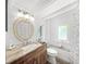 Charming bathroom with stone countertops, unique mirror, and updated fixtures at 2537 Ashton Rd, Sarasota, FL 34231