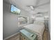 Cozy bedroom with a comfortable bed, ceiling fan, and a window with lots of natural light at 2537 Ashton Rd, Sarasota, FL 34231