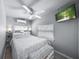 Relaxing bedroom with a ceiling fan, flat screen television, and large windows for ample natural light at 2537 Ashton Rd, Sarasota, FL 34231