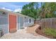 Inviting home exterior with brick pathway leading to colorful doors and lush landscaping, creating a welcoming ambiance at 2537 Ashton Rd, Sarasota, FL 34231