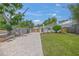 Well-maintained front yard showcases lush green grass, mature trees, and a brick driveway at 2537 Ashton Rd, Sarasota, FL 34231