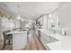 Open-concept kitchen with a farmhouse sink and views of the living room at 2537 Ashton Rd, Sarasota, FL 34231
