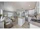 Bright and open living room with white furnishings, modern appliances, and stylish wood-look flooring at 2537 Ashton Rd, Sarasota, FL 34231