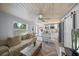 Open-concept living space featuring a renovated kitchen and a cozy living room area with natural light at 2537 Ashton Rd, Sarasota, FL 34231
