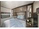 Cozy bedroom featuring built-in storage, overhead cabinets, and natural lighting with a comfortable bed at 2537 Ashton Rd, Sarasota, FL 34231
