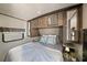 Cozy bedroom featuring built-in storage, overhead cabinets, and natural lighting with a comfortable bed at 2537 Ashton Rd, Sarasota, FL 34231