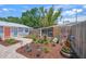 Beautifully landscaped yard featuring a tranquil fountain, lush plantings, and a serene screened-in porch at 2537 Ashton Rd, Sarasota, FL 34231