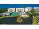 Aerial view of community amenities including tennis courts, pool, and lake at 260 Hidden Bay Dr # 305, Osprey, FL 34229