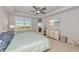Light-filled bedroom with a ceiling fan, neutral carpet, and a sliding glass door at 260 Hidden Bay Dr # 305, Osprey, FL 34229