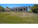 View of screen-enclosed pool from the yard of this residence at 260 Marker Rd, Rotonda West, FL 33947