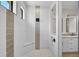 Modern bathroom featuring a spacious shower with a built-in bench and textured tile design at 260 Marker Rd, Rotonda West, FL 33947