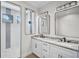 Bathroom with dual sinks, marble countertops, and a glass shower at 260 Marker Rd, Rotonda West, FL 33947
