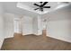 Large bedroom with trey ceiling, wood-look tile floors, and multiple doorways at 260 Marker Rd, Rotonda West, FL 33947
