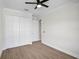Spacious bedroom features a ceiling fan, wood-look tile floors, and a large closet at 260 Marker Rd, Rotonda West, FL 33947