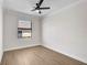 Bright, airy bedroom featuring wood-look tile flooring and a large window at 260 Marker Rd, Rotonda West, FL 33947