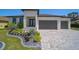 Beautiful single-story home with gray brick driveway and modern landscaping at 260 Marker Rd, Rotonda West, FL 33947