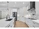 Bright kitchen with white cabinets, stainless steel appliances, and mosaic backsplash at 260 Marker Rd, Rotonda West, FL 33947