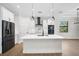 Modern kitchen with stainless appliances, white cabinets, and quartz countertops at 260 Marker Rd, Rotonda West, FL 33947