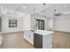 Spacious kitchen features an island with a sink, stainless steel appliances, and wood floors at 260 Marker Rd, Rotonda West, FL 33947