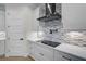 Modern kitchen with white cabinets, stainless steel appliances, and sleek cooktop at 260 Marker Rd, Rotonda West, FL 33947