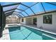 The screened-in pool and spa area are adjacent to the home's covered patio at 260 Marker Rd, Rotonda West, FL 33947